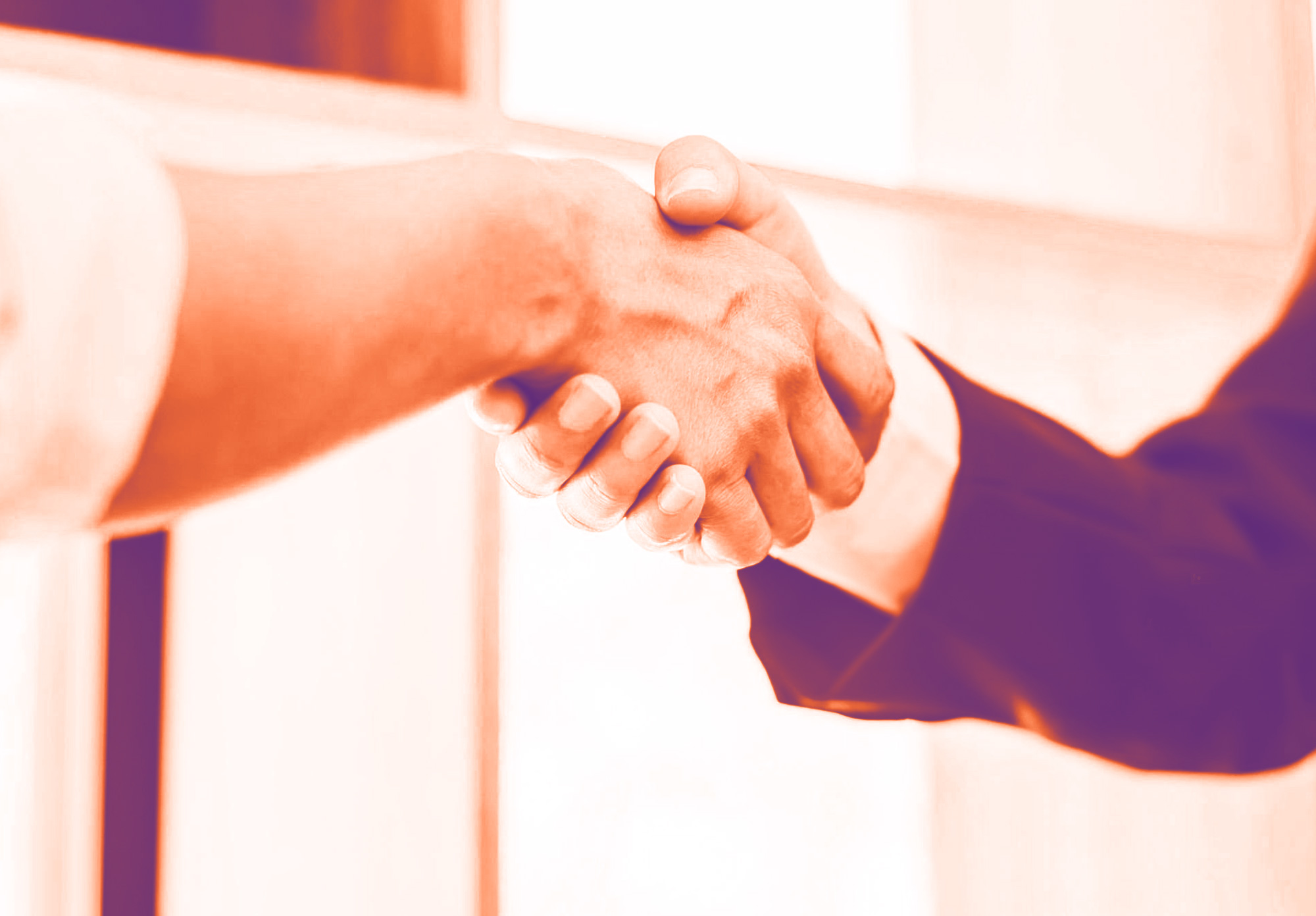 foto con gradiente arancione di due persone che si stringono la mano